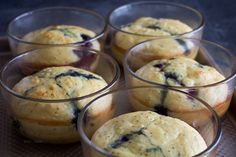 muffins with blueberries in small glass cups on a metal tray, ready to be eaten