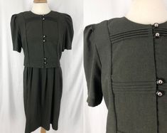 "This vintage 90s dress is in great condition without holes/stains/wear. This dress is a tiny houndstooth style pattern in dark olive green and black. There are pleats on the front as well as silver and black buttons. The back zips up and has a tie at the waist. This dress's is a medium weight and hits around the calf. Note the top of the dress has an additional layer on the inside, as well as thick removable shoulderpads. Overall a lovely unique dress! Size: \"14\", Large Bust: 45 inches Waist: 38 inches (can be tied smaller) Length: 41 inches *Please note all items listed in this store are sourced second hand unless marked otherwise, and are stored in a smoke free/pet free home. I provide as much detail in the description and pictures as I can, however there may be minor imperfections or Green Black Dress, 90s Grunge Dress, Whimsigoth Dress, Military Style Dress, Vintage 90s Dress, Punk Dress, Grunge Dress, Unique Dress, Goth Dress