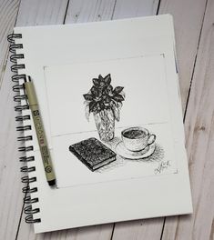 a drawing of a cup of coffee next to a book and pen on a wooden table