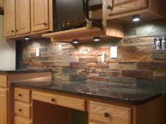 a kitchen with wooden cabinets and stone backsplashes on the counter top,