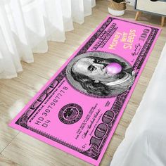 a pink one dollar bill rug on the floor