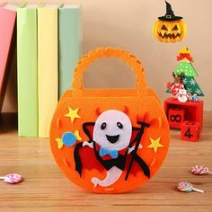 an orange handbag with a cartoon character on it and candy in front of the bag