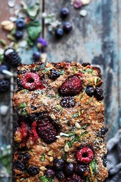 a piece of bread with berries and nuts on it