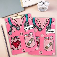 two personalized medical notebooks with stethoscopes on them