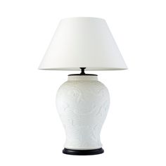 a white lamp with a black base and a white shade on it's side