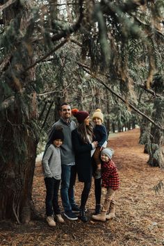 a family posing for a photo in the woods