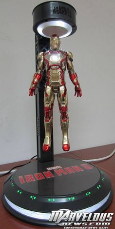 an iron man figurine sitting on top of a table next to a charger