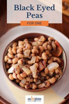 a bowl filled with black eyed peas on top of a white plate