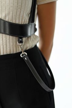 Featuring a subtle belt that is shaped to frame the bust and straps that go over the shoulders, this leather harness is made to flatter your body.Pair it with a t-shirt and satin trousers for a chic, relaxed look or wear it with a dress, for a feminine and sexy outfit. The detachable straps make this piece even more stylish, allowing you to wear the harness is so many ways.- adjustable through buckes at the back and shoulders for a precise fit- made from smooth italian leather- leather thickness Womens Harness Belt, Harness Belt Blazer, Chest Harness Over Dress, Fitted Harness With Adjustable Straps, Black Leather Harness With Adjustable Strap, Black Harness With Belt Loops For Everyday Use, Leather Harness With Straps, Leather Strapped Harness With Belt, Black Leather Harness With Belt Included