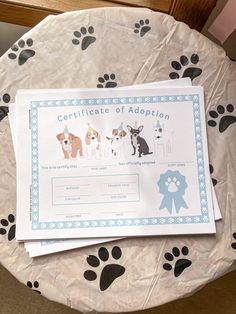 there is a certificate on top of the table with dogs'footprints and paw prints