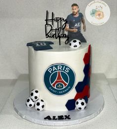 a birthday cake with a soccer theme and a figurine on top that says happy birthday to paris saint - germain