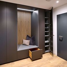 an empty bench in the corner of a walk - in closet next to a door