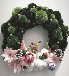 a christmas wreath decorated with poinsettis and ornaments