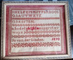 an old fashioned cross stitch sample with the letters and numbers in red on white paper