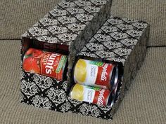 two boxes are stacked on top of each other, with cans in the bottom one