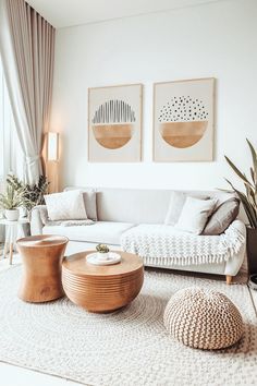 a living room with two pictures on the wall and some furniture in front of it