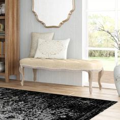 a white bench sitting next to a window in a living room