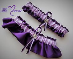 "Beautiful Keepsake garter as well as a Toss-away garter in Orchid and Plum Satin Ribbon and accented with a sparkling rhinestone brooch & garter charm of choice. Your purchase will include both the keepsake garter as well as a toss-away garter. Please measure your thigh to make sure you order the proper size! *Customize this garter set by choosing from our ribbon color chart and leaving requests in the \"note to seller\" box at checkout *These garters are made of quality materials Thanks for lo Ribbon Garter, Lavender Wedding Decorations, Purple Garter, Beach Wedding Purple, Shopify Products, Prom Garters, Garter Wedding, Purple Beach, Glitter Wedding Dress