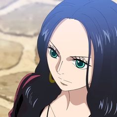 a woman with blue hair and green eyes looks at the camera while standing in front of a desert landscape