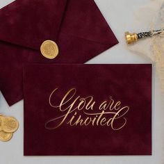 two red envelopes with gold foil lettering on them