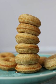 a stack of doughnuts sitting on top of a blue plate