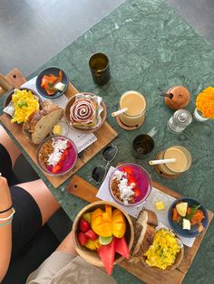 two people sitting at a table with plates of food