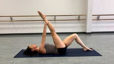 a woman is doing an exercise on a yoga mat