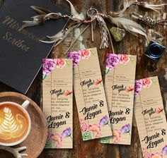 three wedding program bookmarks with flowers on them next to a cup of cappuccino