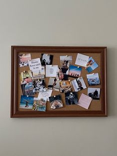 a cork board with pictures and magnets on it