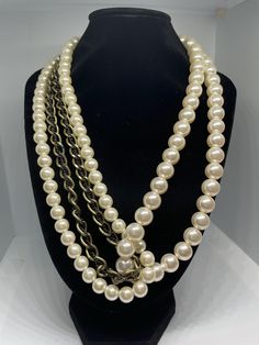 Asymmetrical faux pearl beaded necklace. Two pearl strands and one chain strand with small chain running through it. Larger pearl strand comes down one side and wraps through the other strands, creating and interesting, asymmetrical look. In good vintage condition, minimal wear. Pearl Beaded Necklaces With Chain For Party, Pearl White Beaded Pearl Chain Necklace, Pearl Beaded Necklace With Chain For Parties, Party Pearl Beaded Chain Necklace, Multi-strand Pearl Chain Beaded Necklaces For Party, Evening Multi-strand Pearl Necklace, Pearl Multi-strand Necklace For Parties, Round Beaded Pearl Chain Necklace For Parties, Party Pearl Chain Necklace With Round Beads