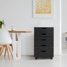 a white dining room with a black filing cabinet