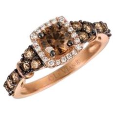 a ring with brown and white diamonds on it's sides, set in 18k rose gold