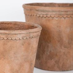 two clay pots sitting next to each other