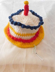 a crocheted cake sitting on top of a bed