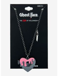 the ghost face necklace has pink icing on it and is attached to a black chain