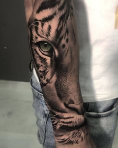 a man's arm with a tiger tattoo on it