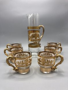 a set of six gold - plated glass cups and saucers