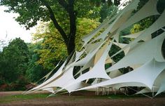 a large white structure sitting in the middle of a park