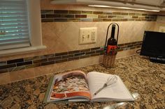 an open book sitting on top of a kitchen counter