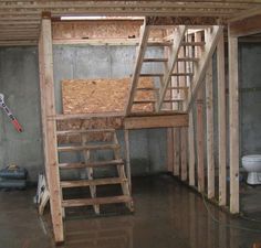 an unfinished room with a ladder, toilet and sink in the corner that is under construction