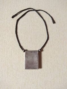 This is a moroccan saharian silver pendant with beautiful engraved decoration and with a thread of leather and two small silver berber beads. This pendant has a good size and weight to be worn. Length of leather thread : 50 cm (19,6 inches) Measures of the pendant : Length : 4,8 cm (1,9 inches) Width : 3,8 cm (1,5 inches) Measures of the silver beads : 0,4 cm x 0,9 cm (0,1 inches to 0,3 inches) Total Weight : 27 g Old Silver Coins, Moroccan Jewelry, Leather Thread, Coin Pendant, Silver Coins, Photo Jewelry, Silver Beads, Cross Pendant, Silver Fashion