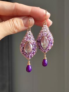 Just like a magical hourglass, purple magical droplets gradually settle down. I am excited about their charm. I carefully crafted this pair using the most exquisite and sturdy weaving method.  ●purple baroque pearls ●purple quartz ●seed beads ●14k gold filled ● total length: 68mm ● weight：4.3g Welcome to visit my Jewelry store: https://www.etsy.com/shop/Ukuly 🌸The delivery time to Most regions of North America, Australia and Europe is usually about 10-15 days. Buyers from Brazil, South Korea, and Indonesia, please provide me with your tax number through messages or notes for smooth shipment. Thank you. 🌸Please let me know your phone number when you place an order. It will be used for shipping label only. 🌸I will pack the goods very carefully and beautifully. They can be used as gifts. ? Purple Briolette Fine Jewelry Earrings, Purple Gemstone Party Earrings, Purple Fine Jewelry Earrings For Gift, Purple Drop Jewelry With Gemstone Accents, Purple Long Drop Jewelry For Gift, Purple Drop Jewelry For Party, Purple Drop Earrings With Gemstone Accents, Purple Gemstone Accented Drop Earrings, Purple Long Drop Earrings For Gift