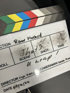 a close up of a movie clapper with writing on the front and back of it