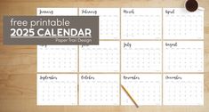 the free printable calendar is displayed on a wooden table with a cup of coffee