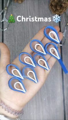 four pairs of scissors in the palm of someone's hand with snowflakes on it