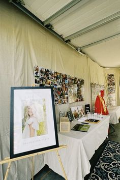 a table with pictures on it under a tent