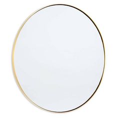 a round white mirror with gold trim