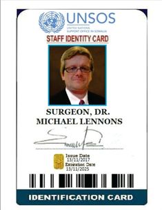 a identification card for a man who is wearing glasses and a suit with a tie