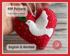 a red heart shaped ornament with a white dove on it