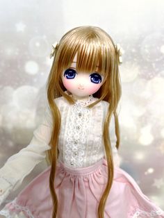 a doll with long blonde hair and blue eyes wearing a pink dress in front of a white background